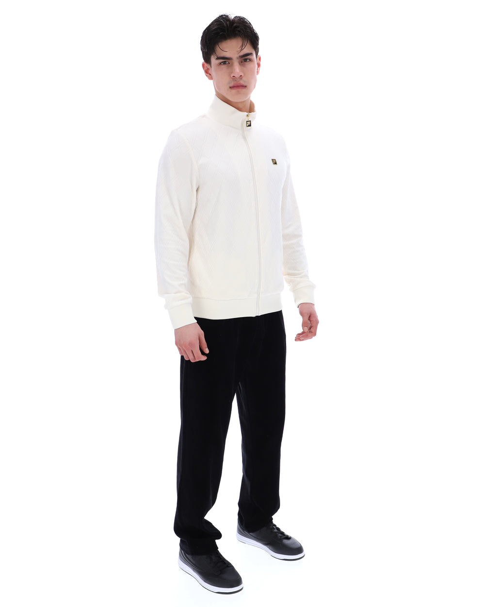 Man wearing a white sweater and black pants on a white background