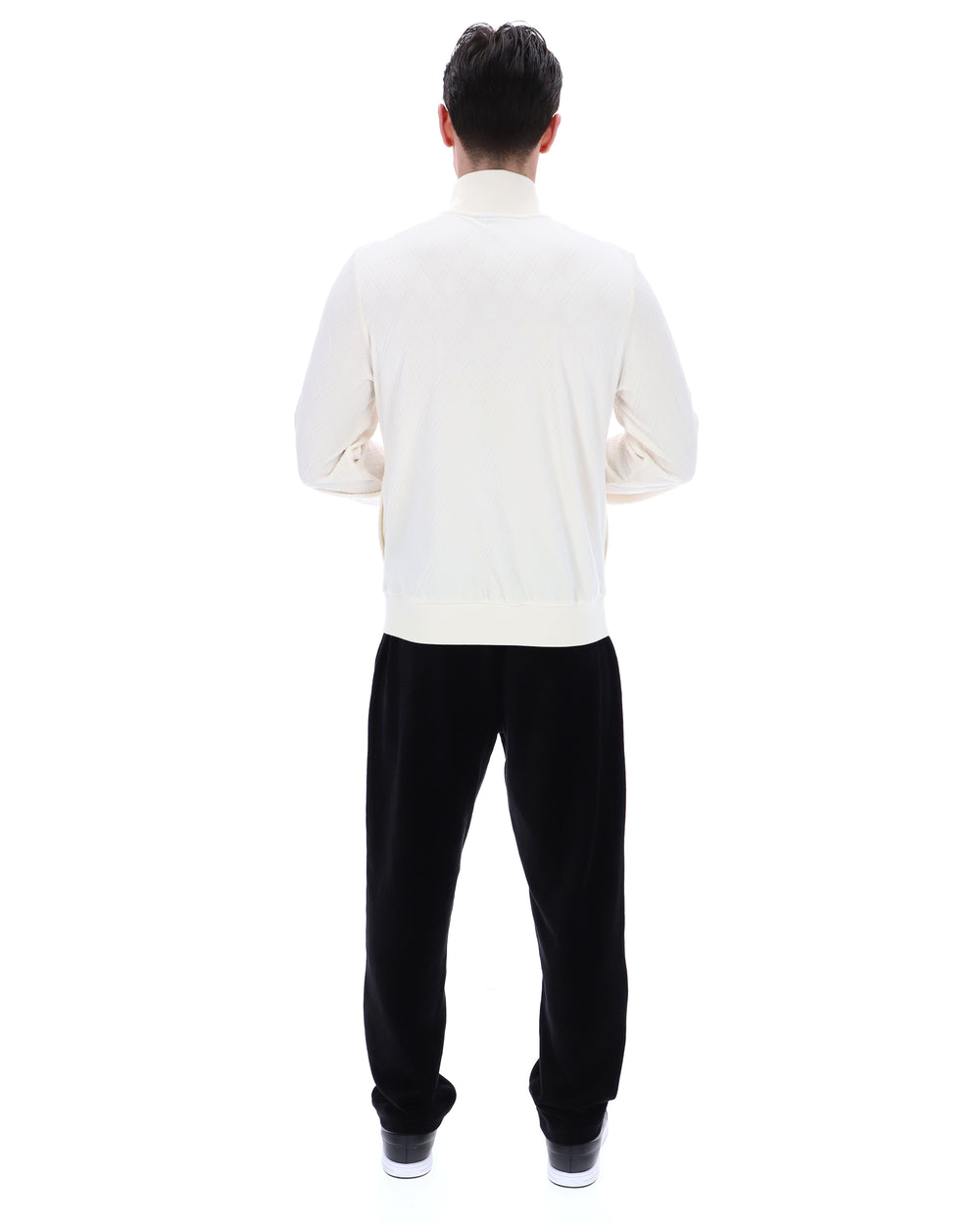 Person wearing a white shirt and black pants on a white background