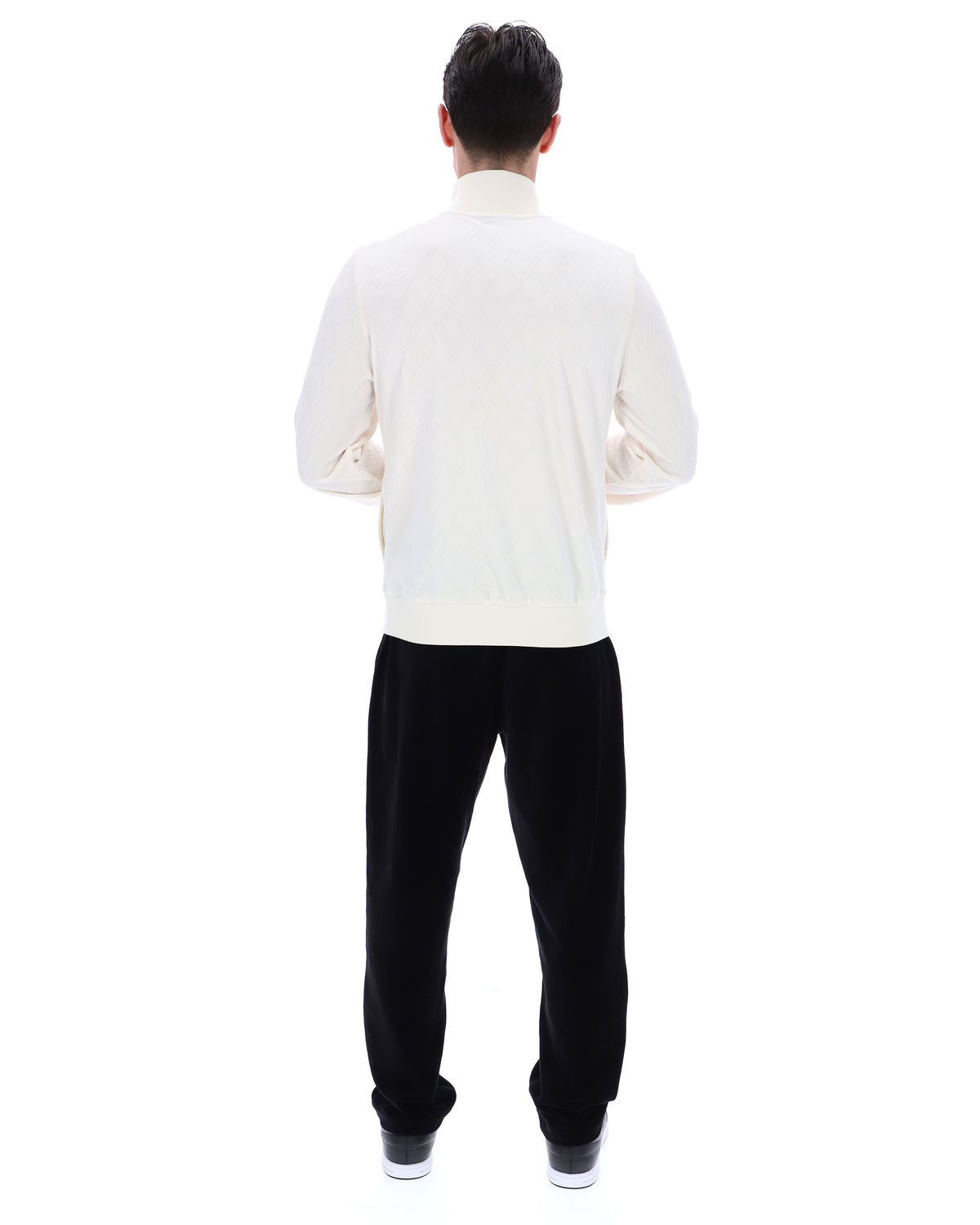 Person wearing a white shirt and black pants on a white background