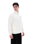 Person wearing a white high-neck sweater on a white background