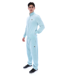 Man wearing a light blue tracksuit on a white background