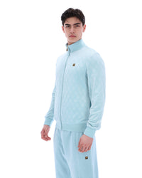 Man wearing a light blue tracksuit with a brand logo on a white background