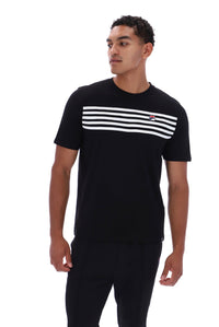 A man wearing a black short-sleeve t-shirt with a horizontal white stripe pattern across the chest and a small red and white FILA logo on the left chest, paired with black pants, against a plain white background.