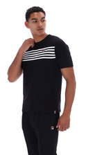 A man wearing a black short-sleeve t-shirt with a horizontal white stripe pattern across the chest and matching black sweatpants, featuring the Fila logo on the chest and thigh.