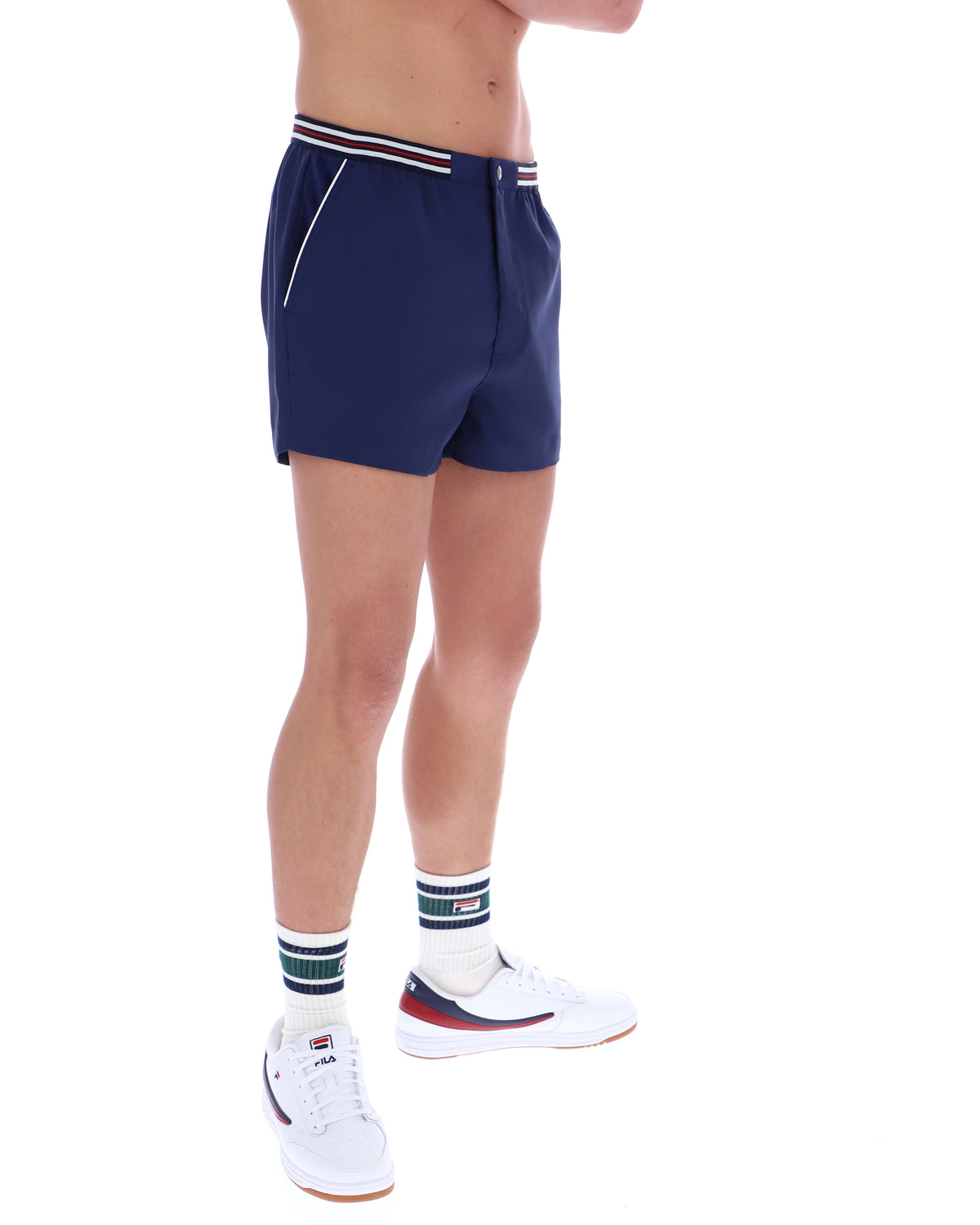 Person wearing navy shorts with white stripes on a white background