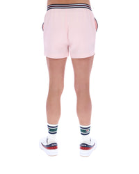 Pink shorts worn by a person on a white background