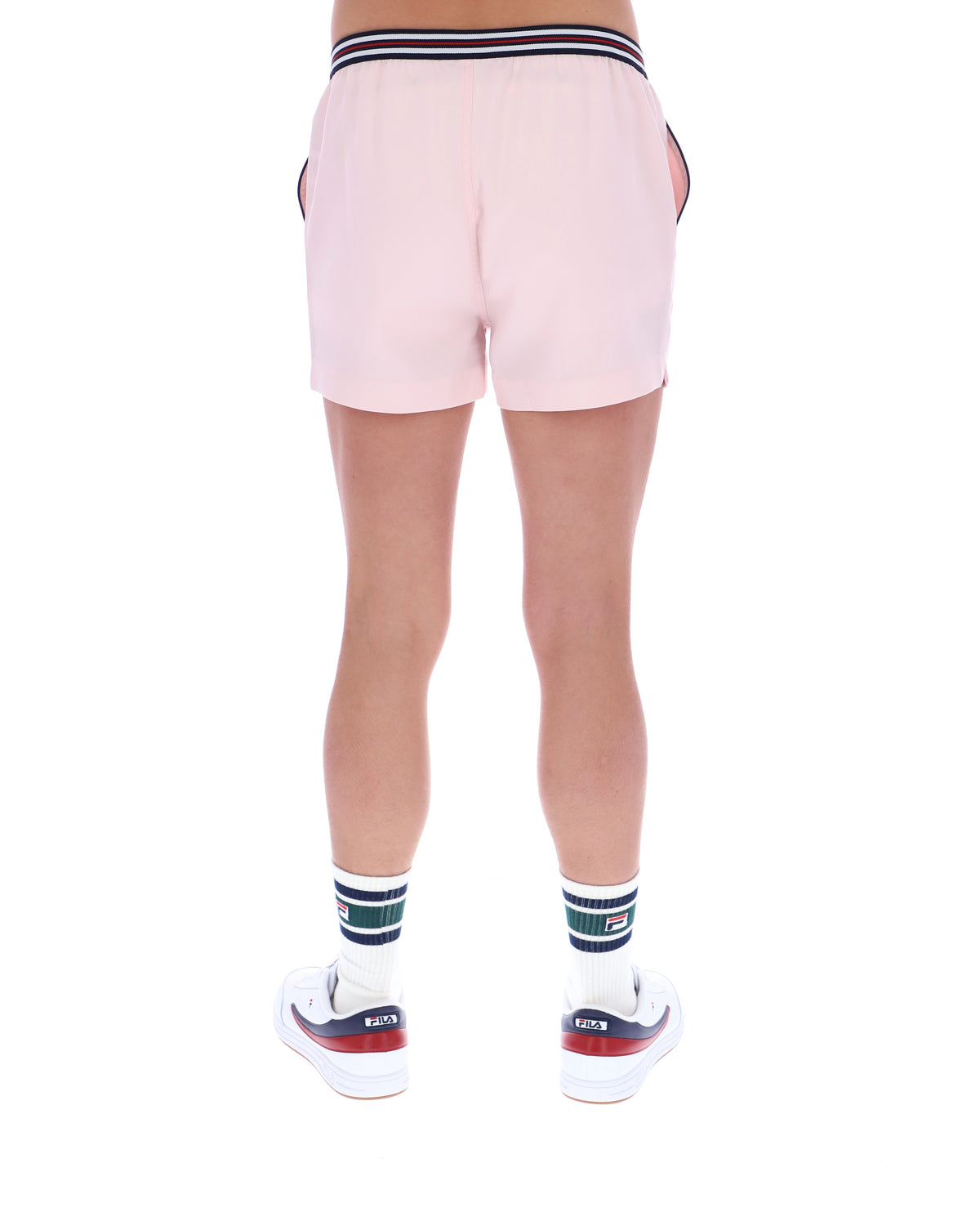 Pink shorts worn by a person on a white background