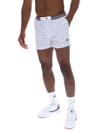 Person wearing white checkered shorts with a brand logo on a white background