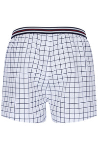 Grid-patterned shorts with a striped waistband on a white background