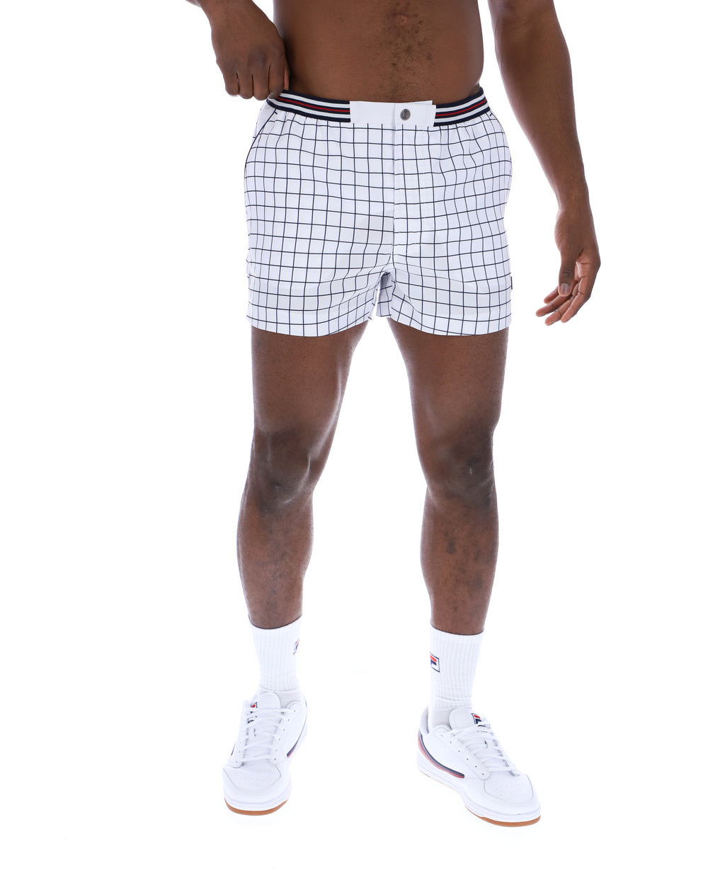 Person wearing white checkered shorts on a white background