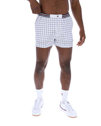 Person wearing white checkered shorts on a white background