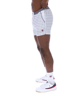 Person wearing white checkered shorts with a brand logo on a white background