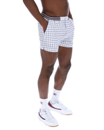 Person wearing white checkered shorts on a white background