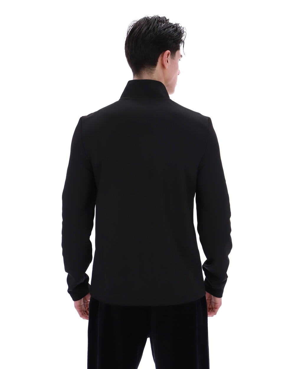 Person wearing a black tracksuit on a white background