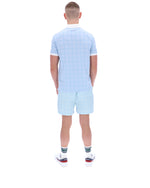 Person wearing a light blue checkered outfit on a white background