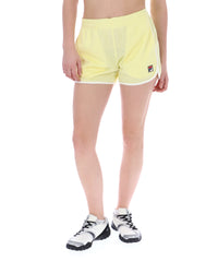 Person wearing yellow athletic shorts with a brand logo on a white background