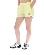 Person wearing yellow shorts with a brand logo on a white background