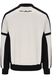 A colorblock crewneck sweatshirt shown from the back, featuring an off-white body with black shoulder, sleeve, and hem panels, and '1911 Italia' embroidered in black script at the top collar.
