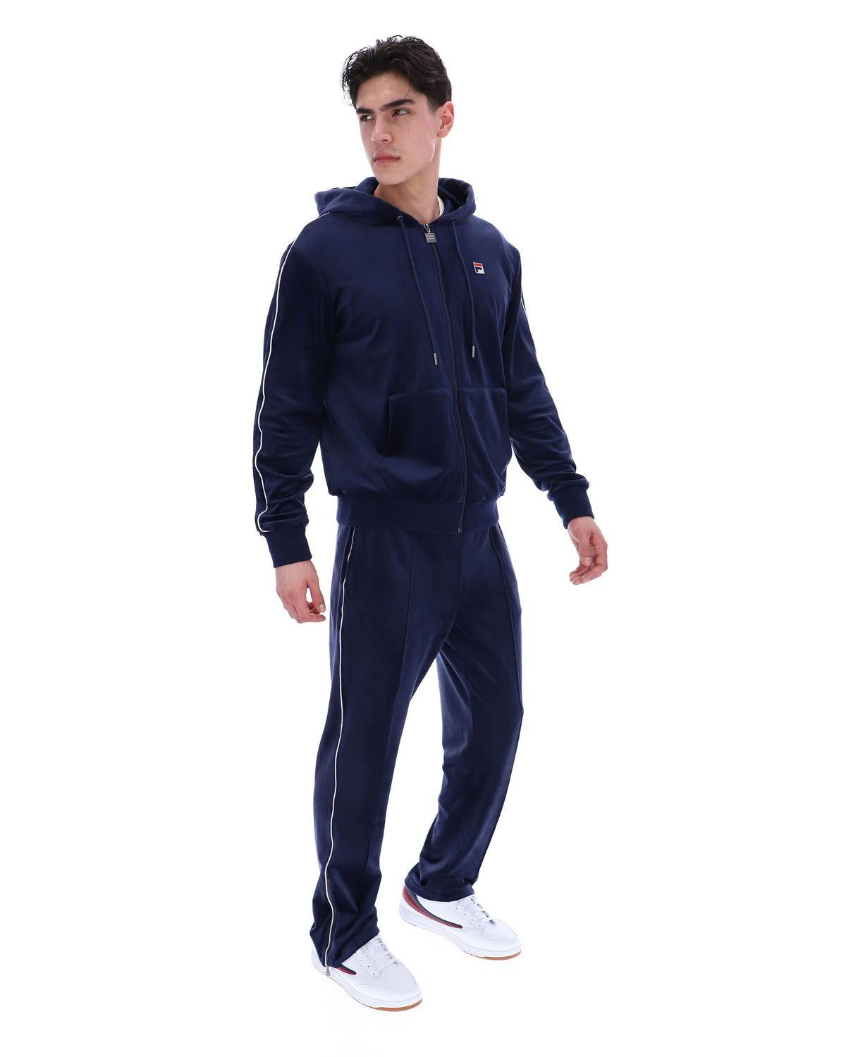 Displays a model wearing the Navy 'Fila' branded Italo Velour Hoodie