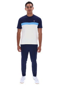A man modeling a short-sleeve colorblock t-shirt and matching navy pants. The t-shirt features a navy blue upper section, a light blue horizontal stripe across the chest, and a large white block on the lower half.