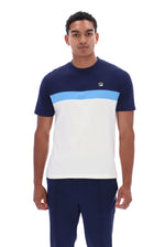 A man wearing a color-blocked short-sleeve t-shirt by FILA in navy blue, light blue, and white, paired with navy pants, against a plain white background.