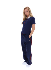 Displays a model wearing the Navy 'FILA' branded Juno Fitted Iconic Polo