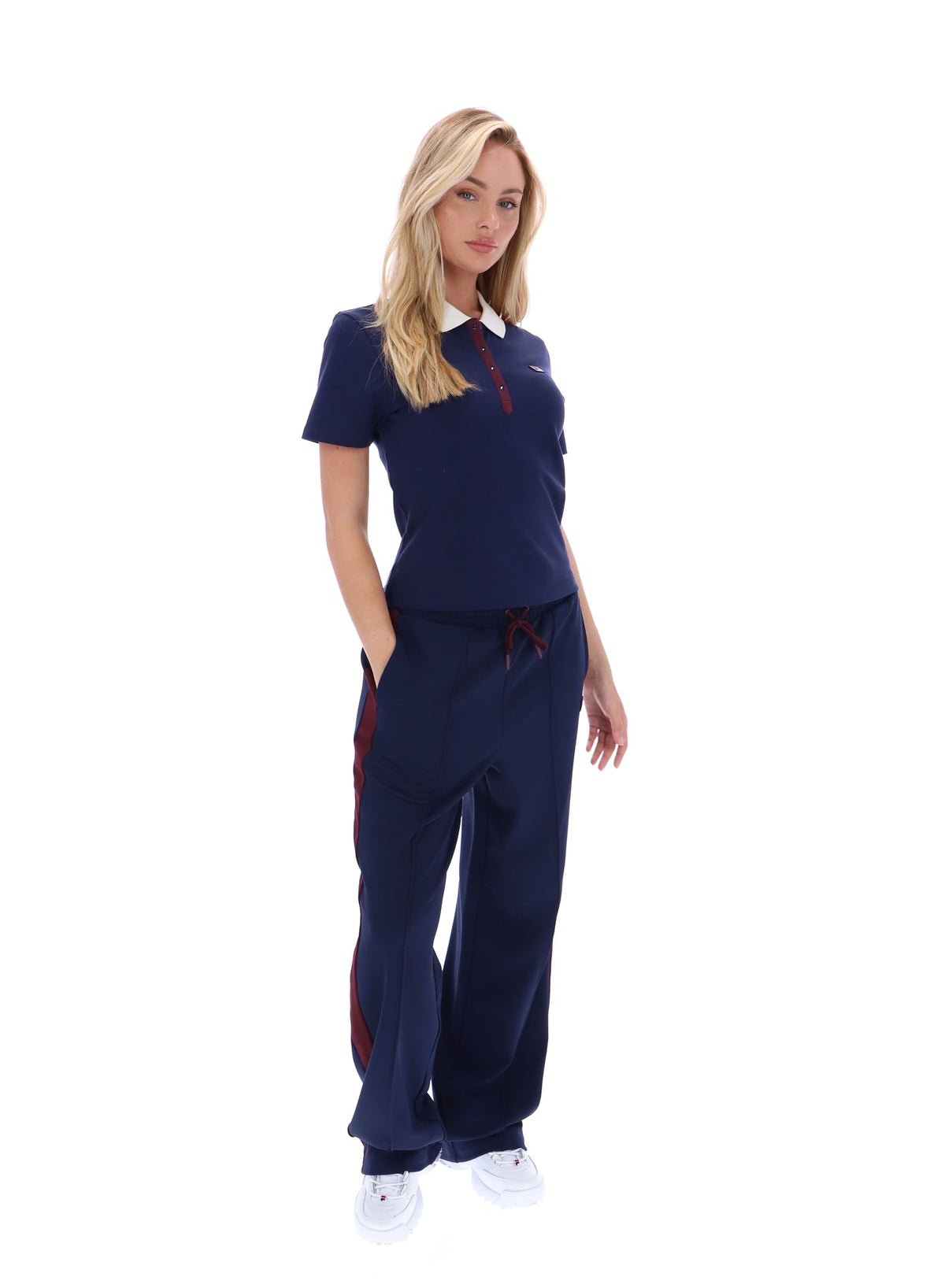Displays a model wearing the Navy 'FILA' branded Juno Fitted Iconic Polo