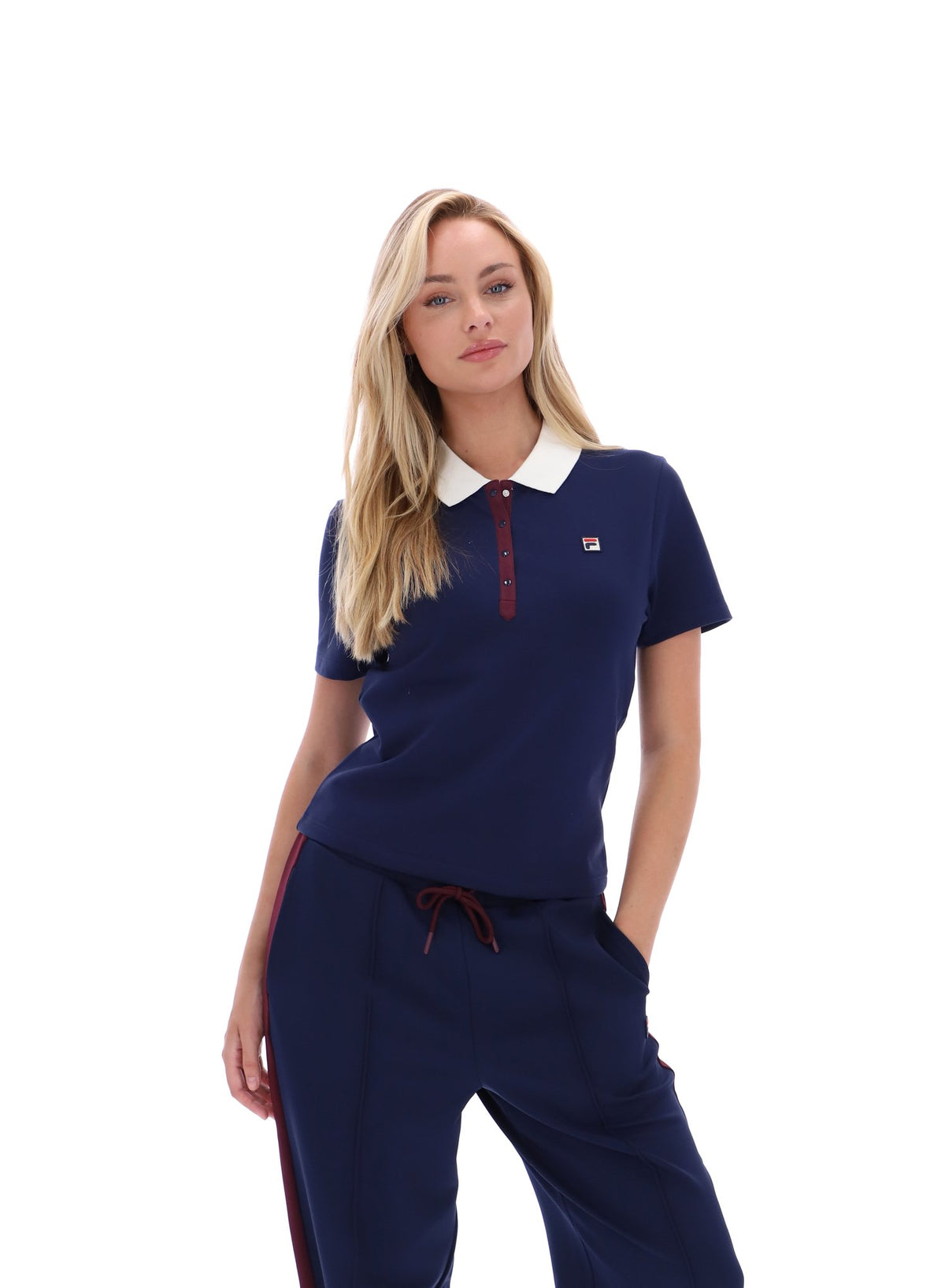 Displays a model wearing the Navy 'FILA' branded Juno Fitted Iconic Polo