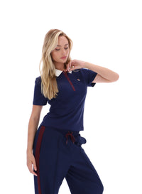 Displays a model wearing the Navy 'FILA' branded Juno Fitted Iconic Polo