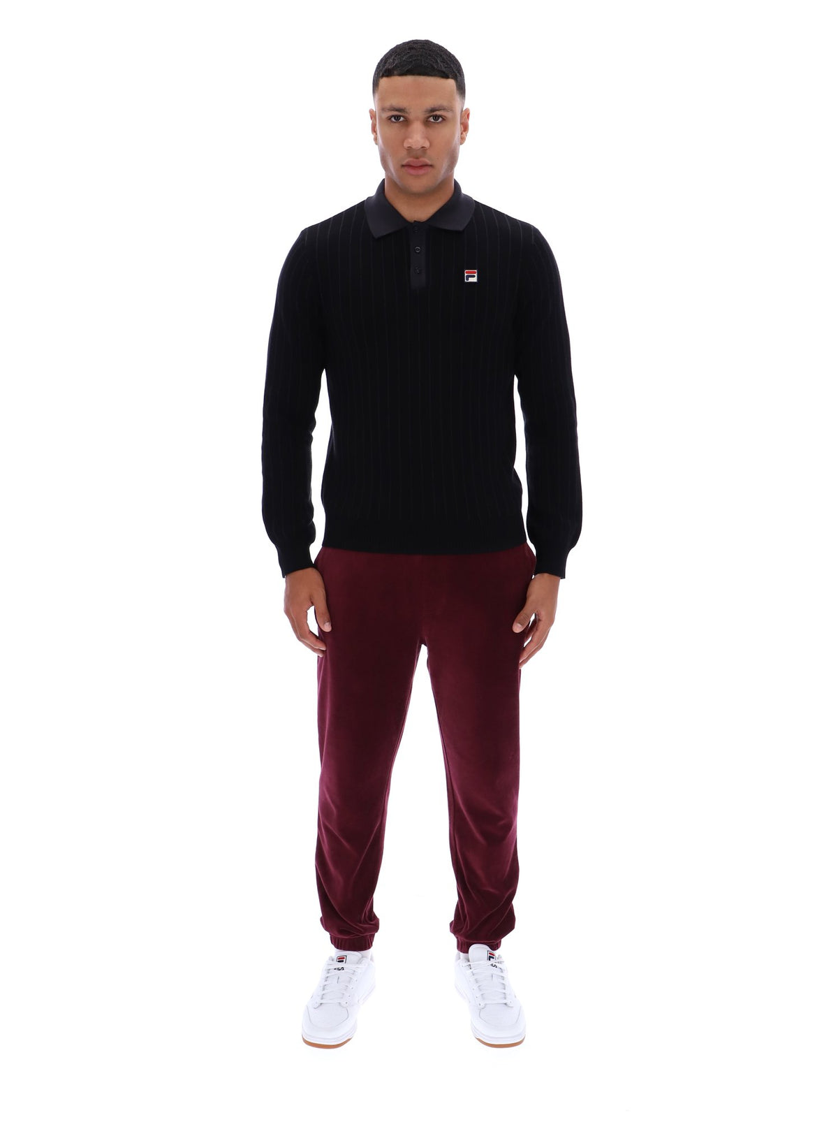 Displays a model wearing the Black 'FILA' branded Kobe Striped Knit Polo