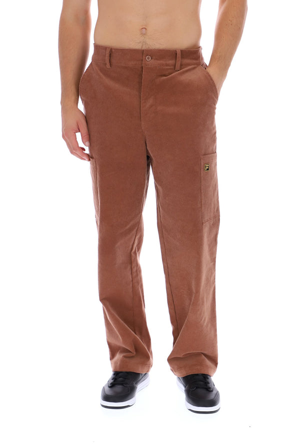 A man wearing brown corduroy cargo pants with black sneakers, shown from the waist down against a white background.