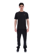 Man wearing a black athletic outfit with a logo on a white background