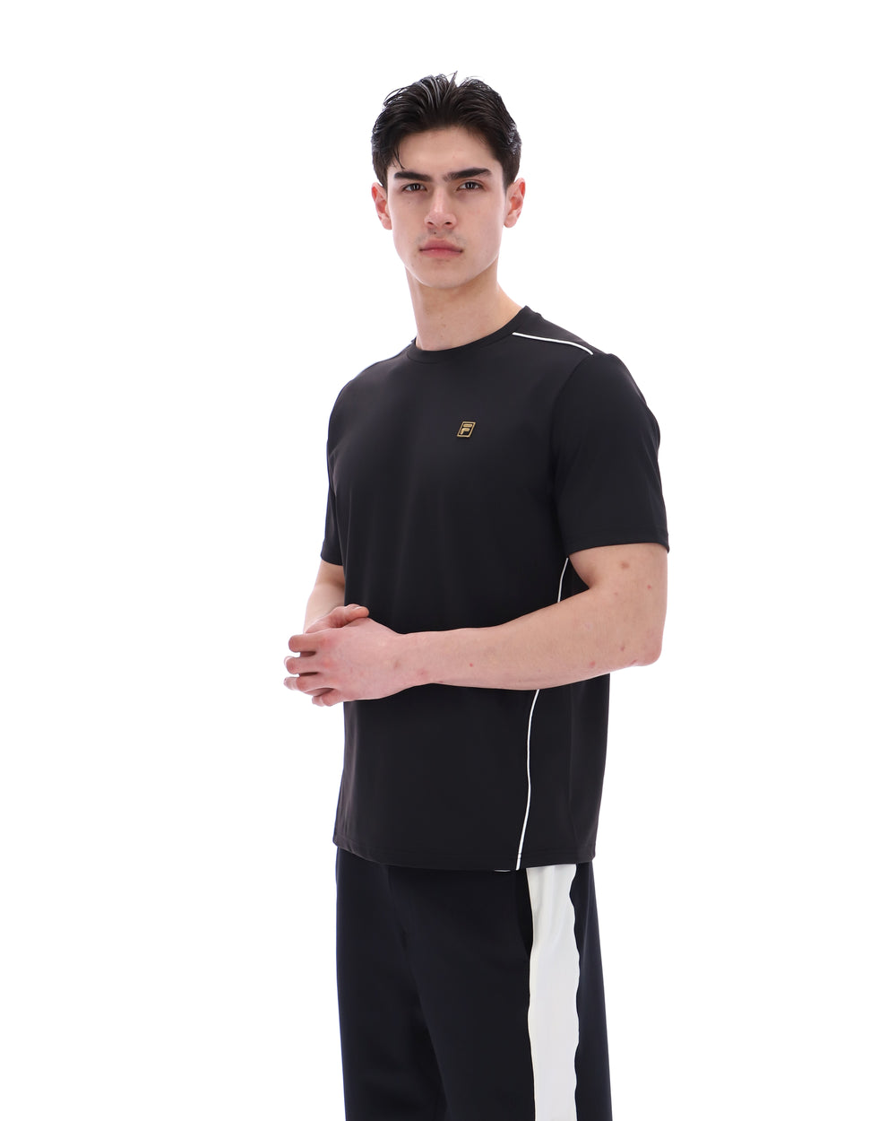 Man wearing a black outfit with a logo on a white background