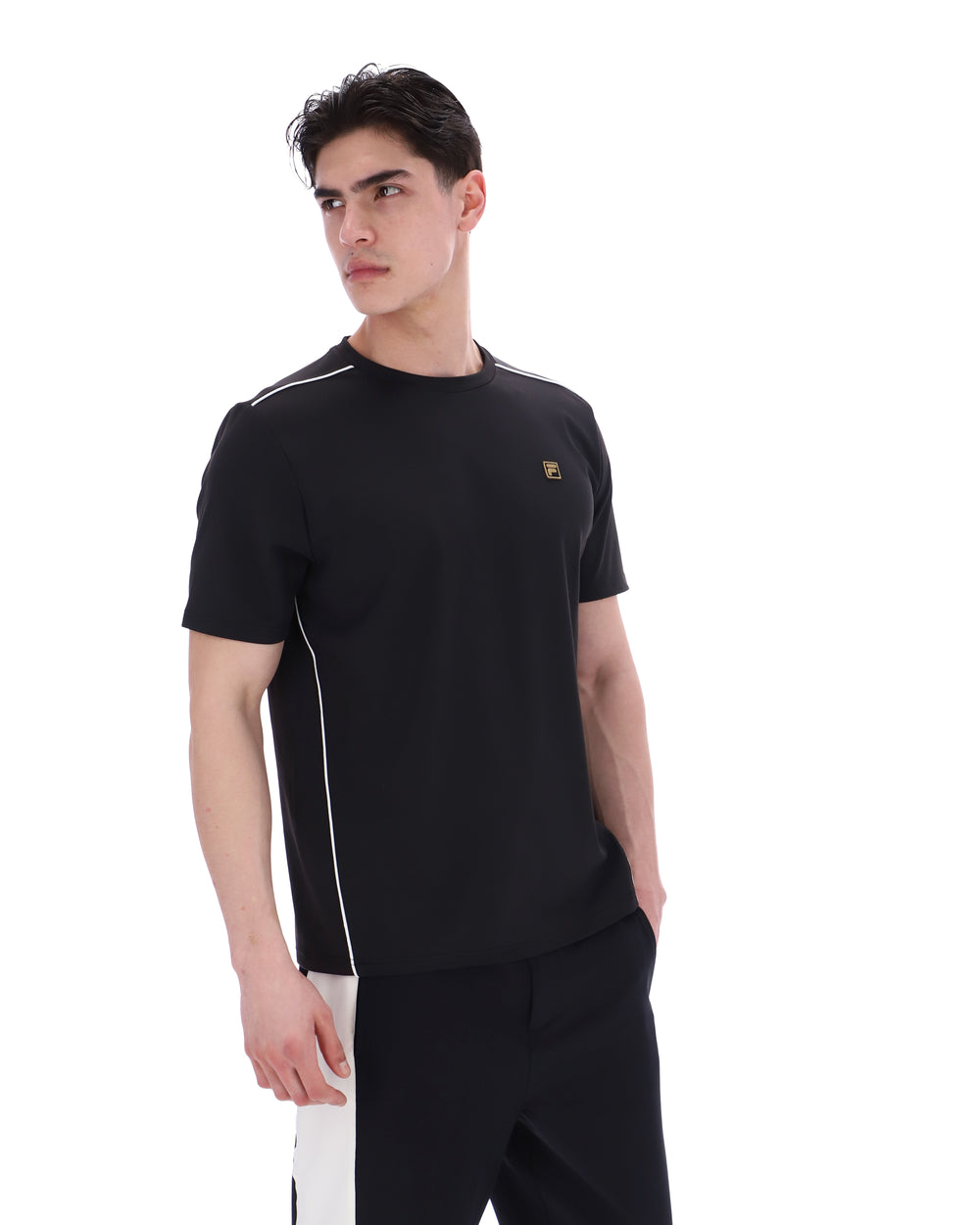 Man wearing a black t-shirt with white accents on a white background