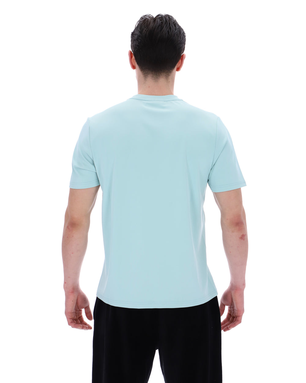 Person wearing a light blue t-shirt on a white background
