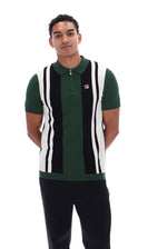 A man wearing a green, black, and white striped knit polo vest with a small red and white Fila logo on the chest, paired with black pants, against a plain white background.