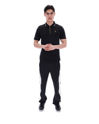 Man wearing a black outfit with white stripes on a white background