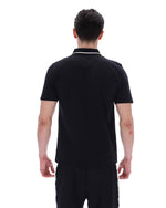 Man wearing a black polo shirt on a white background
