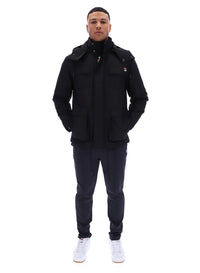 Displays a model wearing the Black 'FILA' branded Liam Cargo Padded Jacket