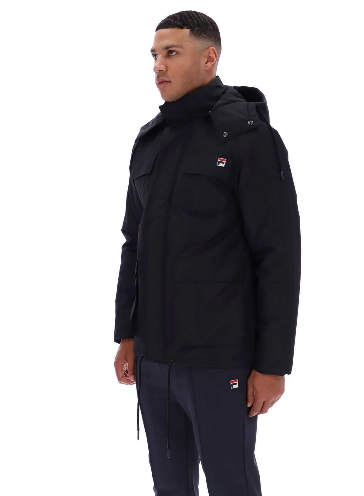 Displays a model wearing the Black 'FILA' branded Liam Cargo Padded Jacket