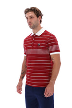 A man wearing a red short-sleeve polo shirt with thin white horizontal stripes, a white collar, and a small Fila logo on the chest, paired with navy blue pants, set against a plain white background.