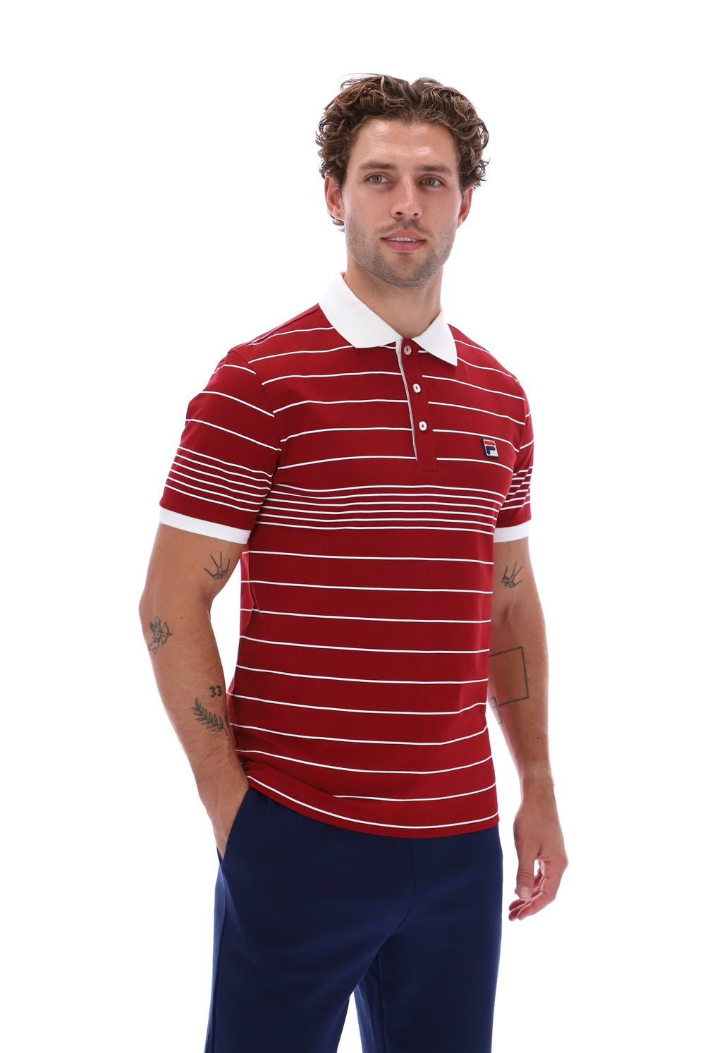 Displays a model wearing the Sun Dried 'FILA' branded Tomato/ White Logan Stripe Polo