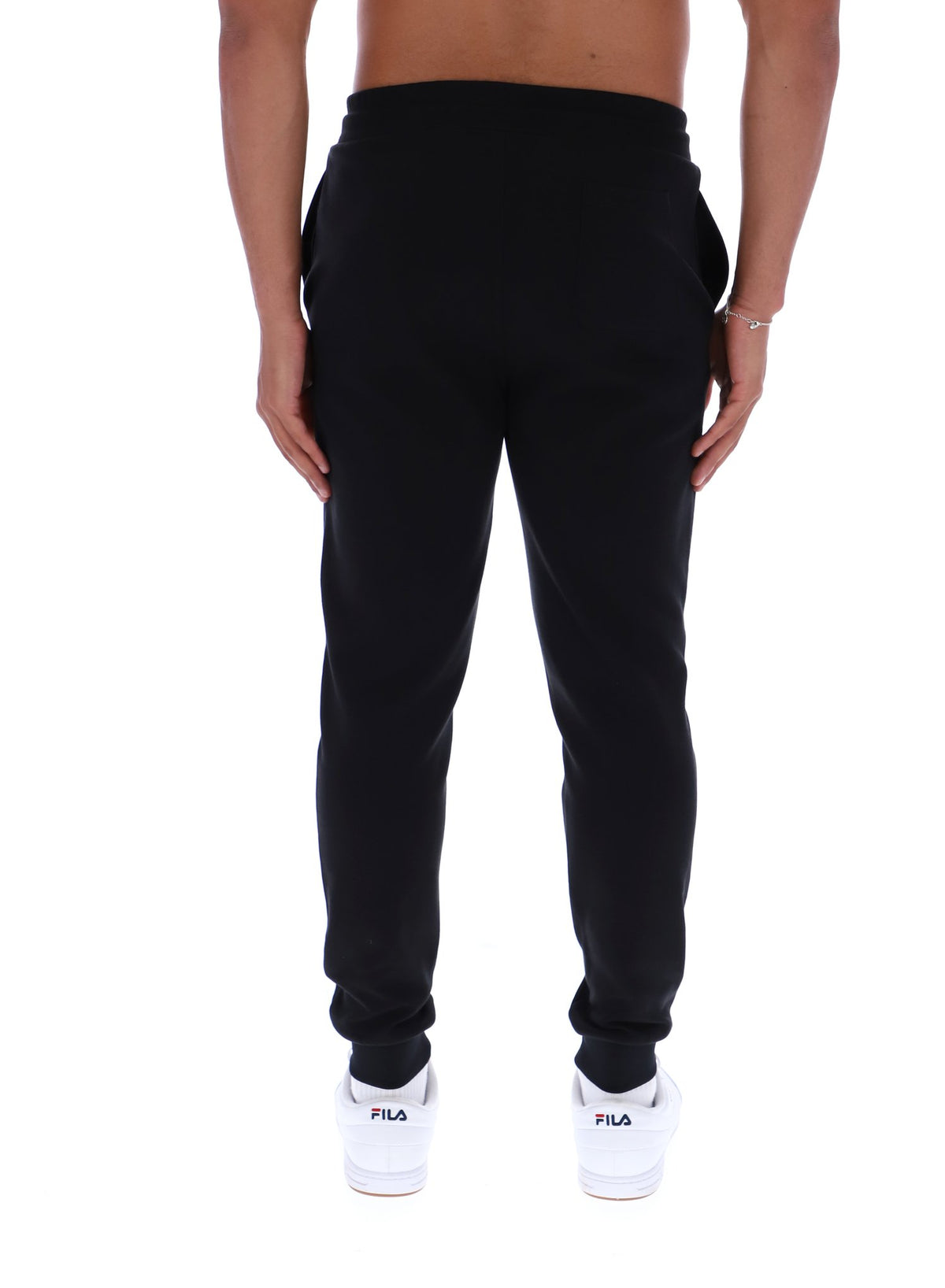 Black sweatpants worn by a person on a white background