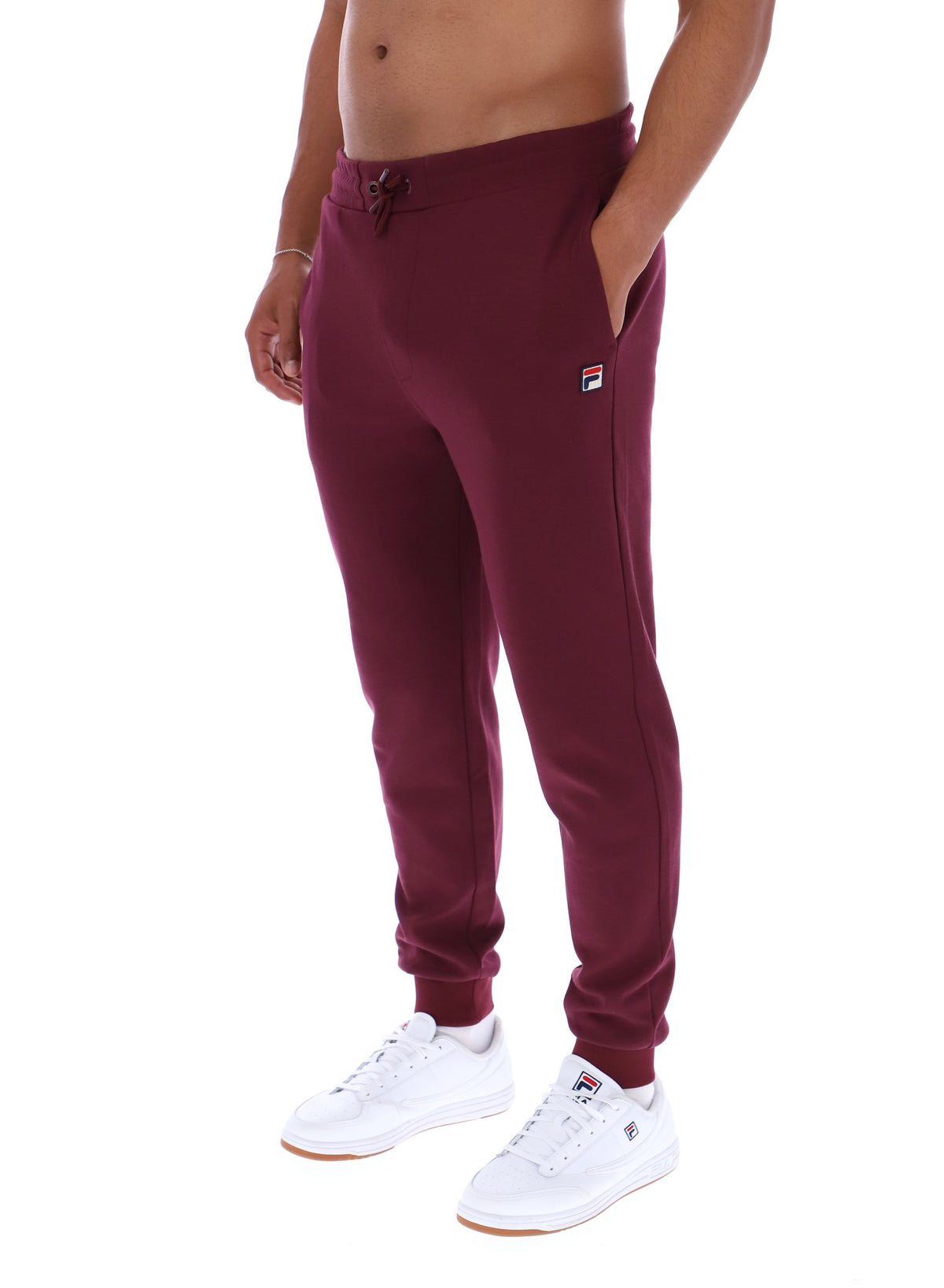 Maroon sweatpants worn by a person on a white background