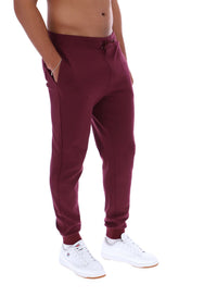 Maroon sweatpants worn by a person on a white background