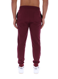 Maroon sweatpants worn by a person on a white background