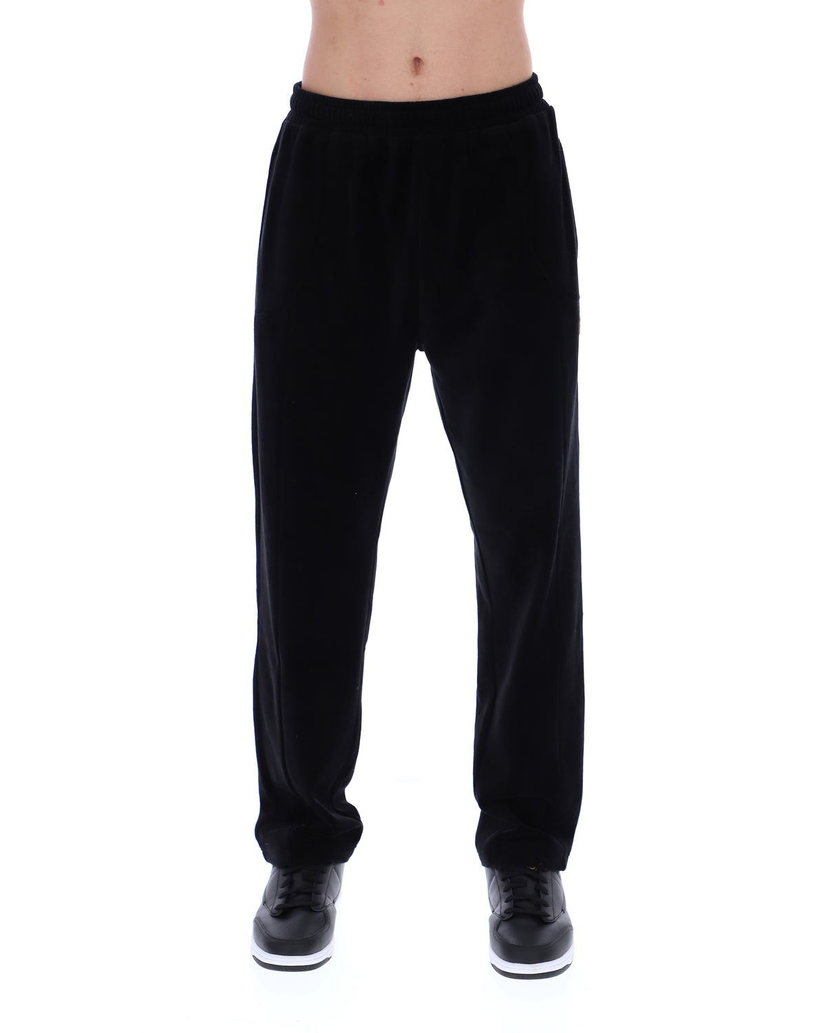Displays the model wearing the Black 'FILA' branded Lorrie Velour Track Pant