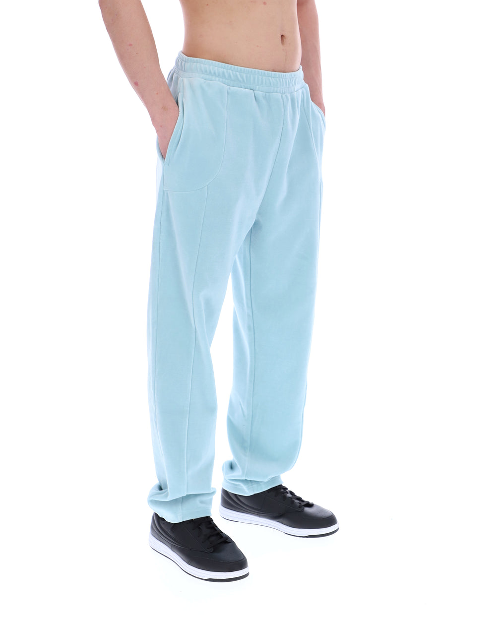 Light blue velour sweatpants worn by a person on a white background