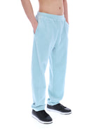Light blue velour sweatpants worn by a person on a white background