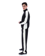 Person wearing a black and white tracksuit on a white background